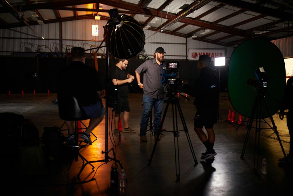 Photographers set up in a warehouse studio with lighting and camera equipment in Orlando, Florida.